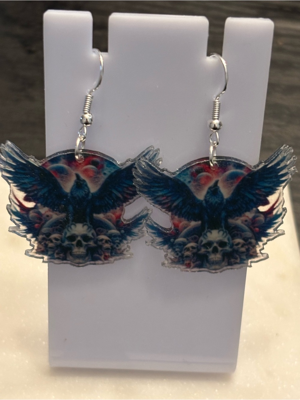 Title: Raven Skull Pile Acrylic Dangle Earrings | Cosmic Raven on Skulls | Silve